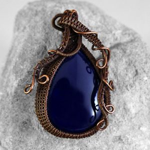Midnight blue drop shaped stone in an oxidised bronze wire wrapped setting