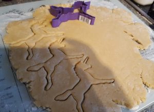 Biscuit dough with unicorn shapes cut out