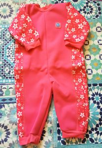 pink with white flowers child's wet suit with white flowers 
