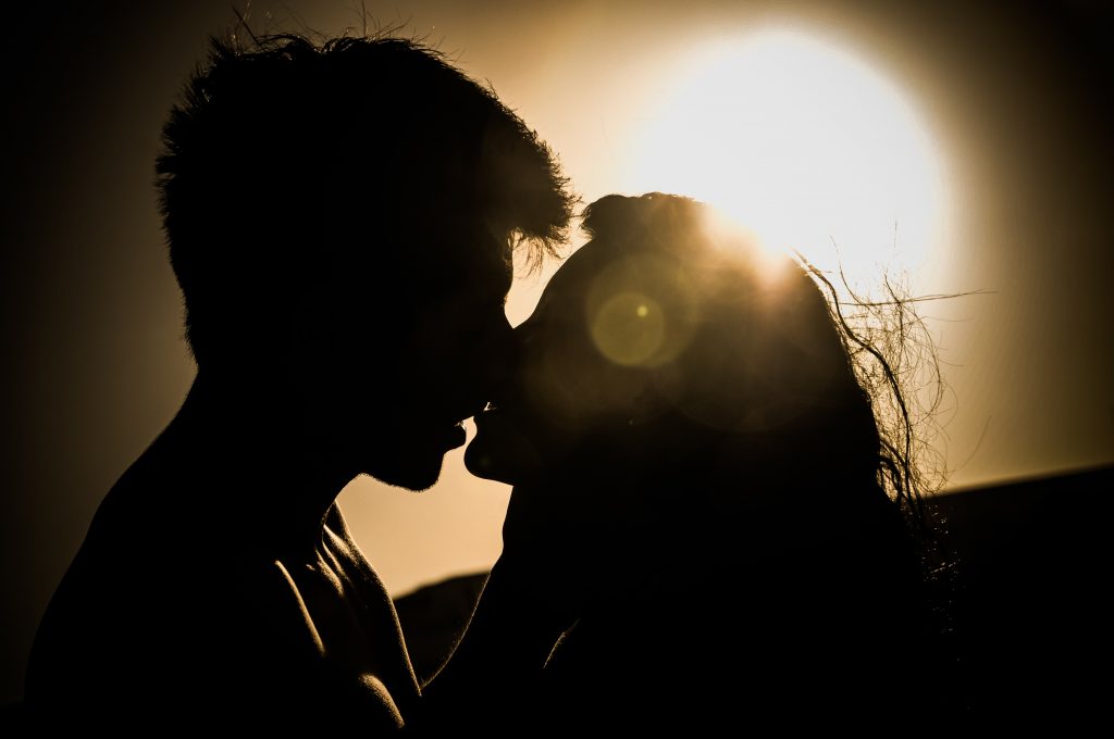 Kissing couple at sunset