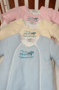 Magic sleepsuit close up of pink blue and yellow fronts