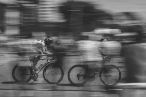 a blurred busy scene with bikes racing past
