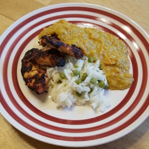 tandoori chicken and rice on a plate