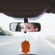 woman looking in rear view mirror