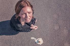 woman dropped an icecream staring up at the sky upset