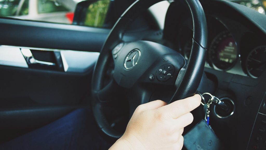 hand on a steering wheel