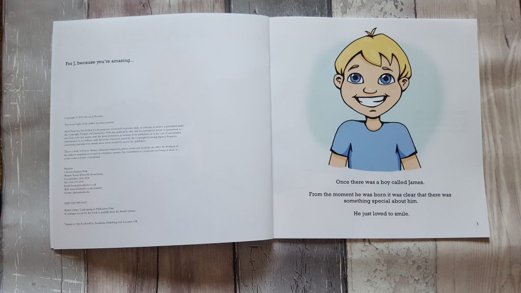 book open on first page with the character james smiling he has blonde hair and blue eyes and is wearing a blue tshirt