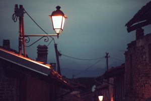 street lamp lit next to a roof