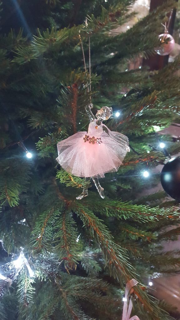 a clear glass ballerina christmas decoration with a pink net skirt