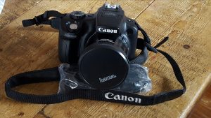 my new canon dslr camera sat on a wooden table