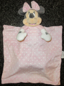 a minnie mouse toy with a pale pink bow attached to a pale pink and white spotty blanket - it is a child's comforter from Disney. She is called Mimmie