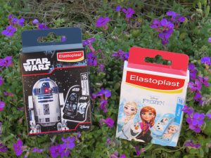 a packet of star wars and frozen plasters in with little purple flowers