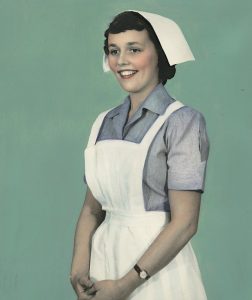an old picture of an old fashioned nurse in uniform smiling at the camera