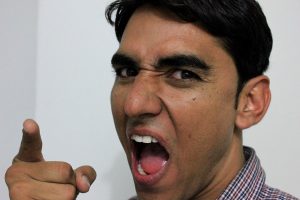 angry man pointing at the camera with mouth open
