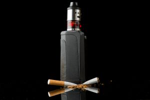 Tobacco cigarette crushed under electronic cigarette