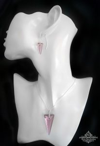 a white ceramic bust with pink triangular swarovski crustal earrings and necklace on silver chain displayed on it