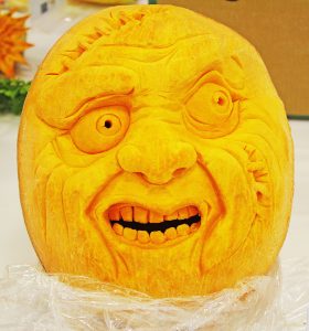 a pumpkin carved into the face of a monster