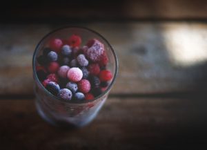 a glass full of frozen summer berries