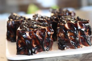 slabs of cake covered in chocolate sauce