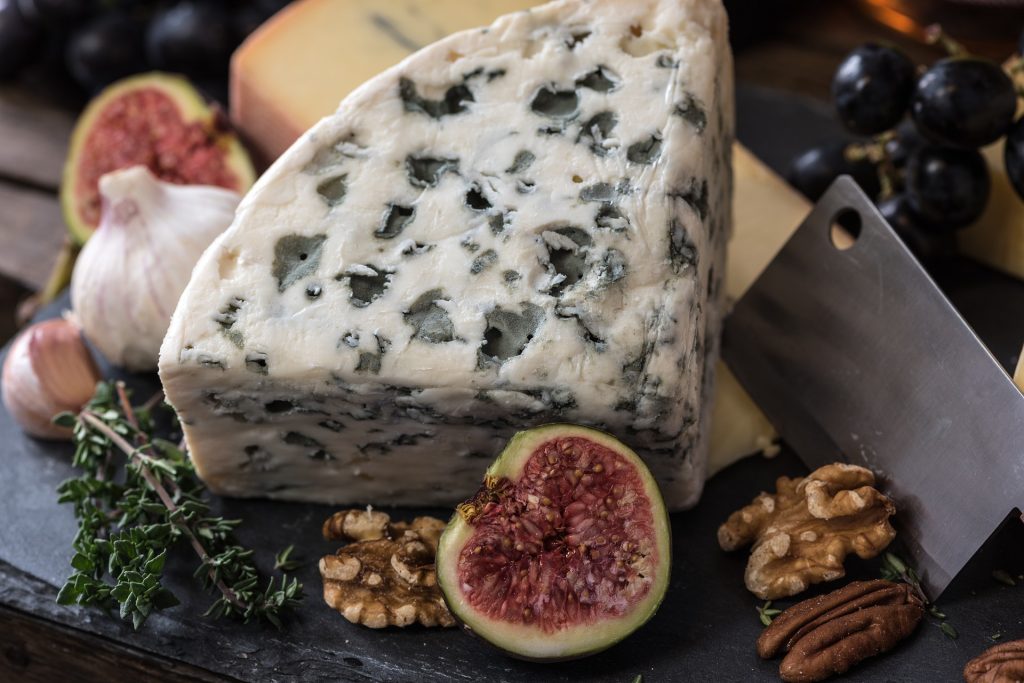 a plate of cheese and figs