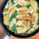 the brie and herb frittata in a skillet, cooked