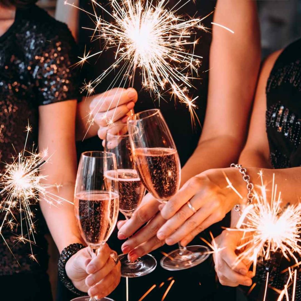 finding the perfect venue hands clinking glasses with sparklers