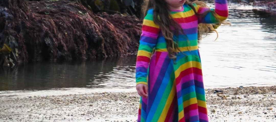 alyssa by the rockpools in her rainbow childrensalon dress
