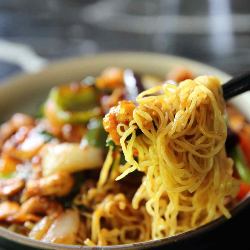 a bowl of chinese food with noodles