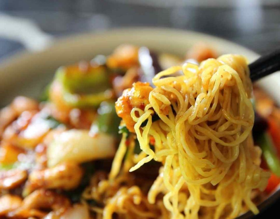 a bowl of chinese food with noodles