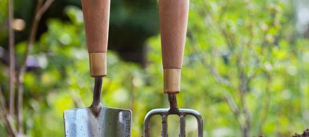 make gardening easier - a trowel and fork in the ground