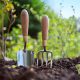 make gardening easier - a trowel and fork in the ground
